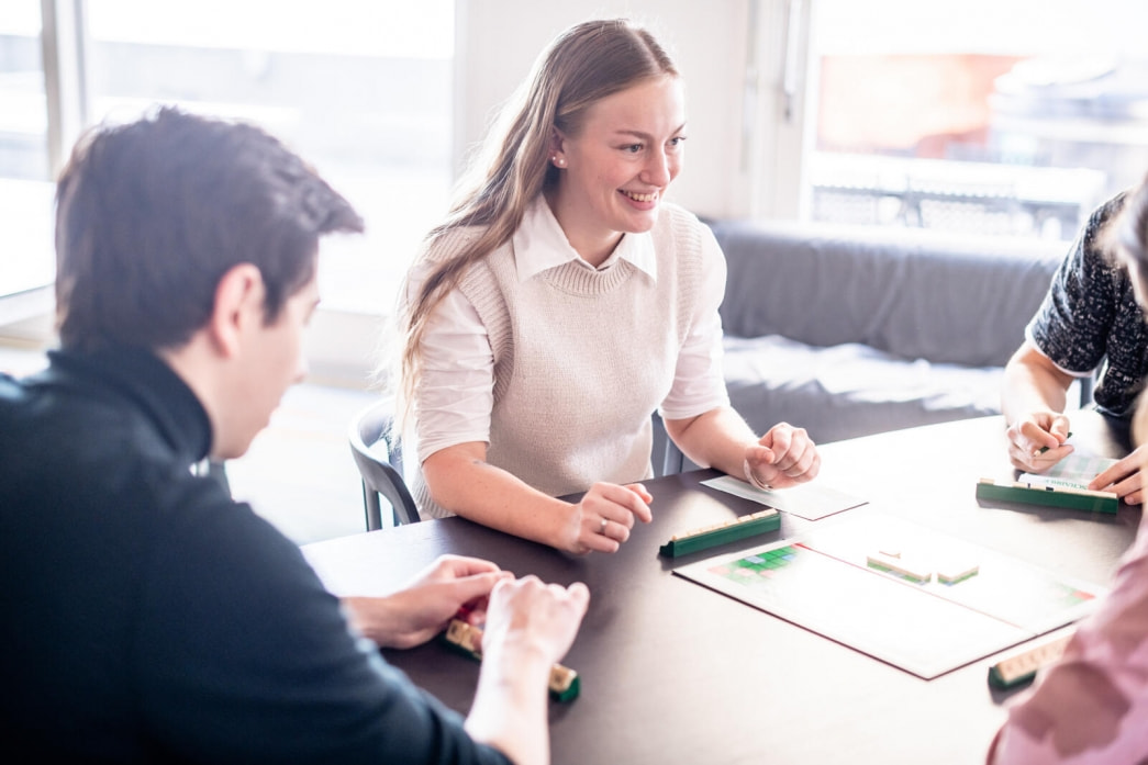 Mette enjoys playing scrabble with classmates